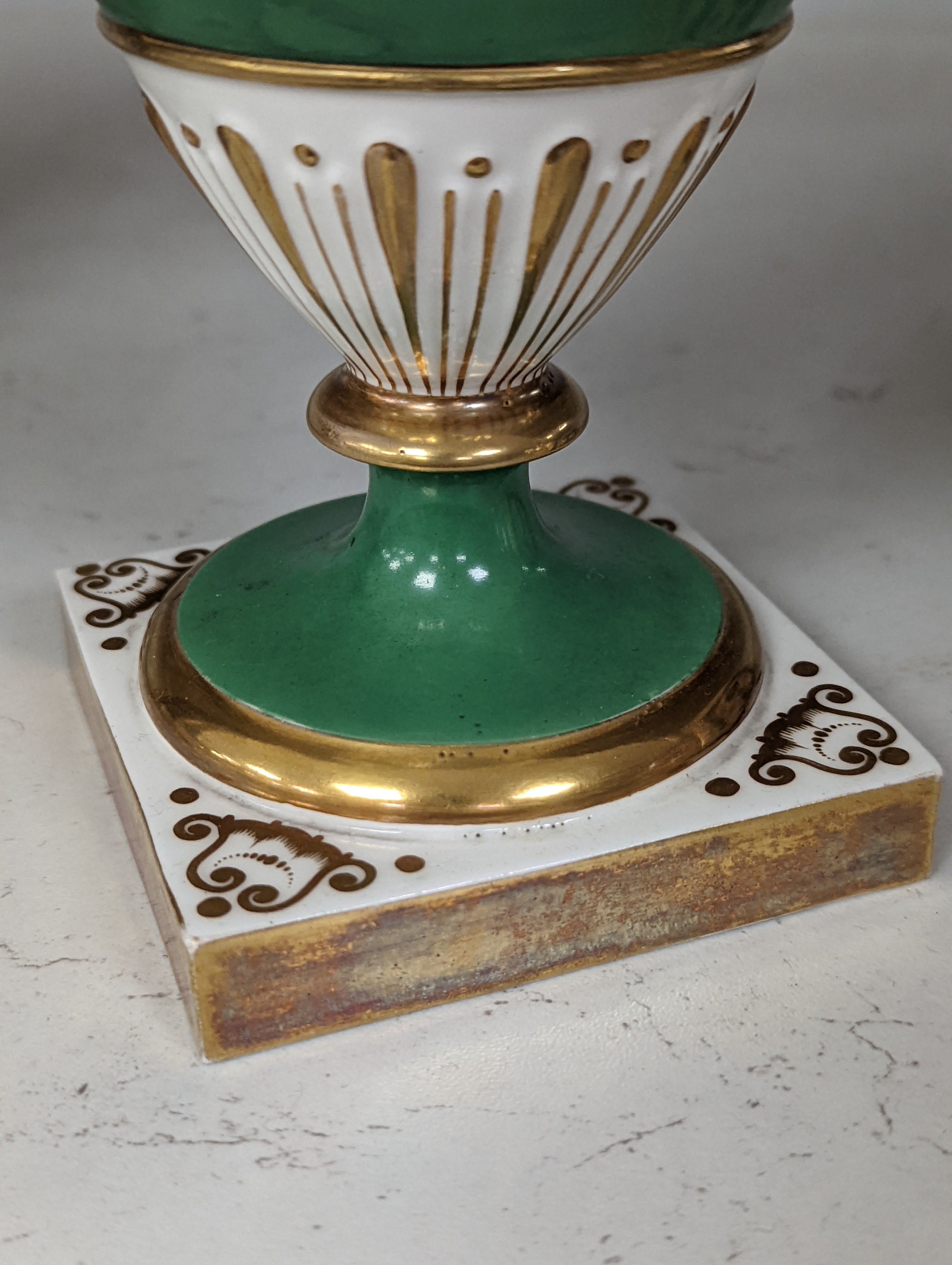 An English porcelain two handled vase painted with flowers in a panel on a green ground, probably Grainger Worcester, c.1830, height 24cm